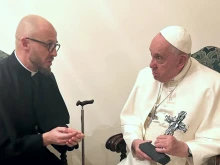 Father Vyacheslav Grynevych gave Pope Francis with a cross made out of broken glass and rubble from destroyed buildings in Kyiv on Feb. 21, 2023.