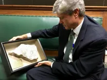 Congressman Jeff Fortenberry holds a fragment of an Iraqi Christian altar destroyed by the Islamic State. Courtesy photo