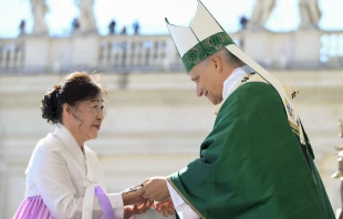 Pope Leo XIV hands a crucifix to a newly instituted catechist during Mass in St. Peter’s Square at the Vatican on Sept. 28, 2025. Credit: Vatican Media