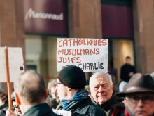 People in Strasbourg, France, hold placards reading "Catholics, muslims, jews all are Charlie" during a unity rally on Jan. 11, 2015 following a mass shooting by Muslim terrorists at the offices of the French satirical weekly newspaper Charlie Hebdo in Paris.