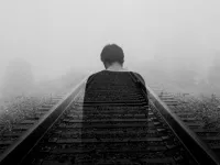 Ghostly man on train tracks / Photo by Gabriel on Unsplash