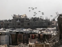 A plane drops food aid over Rafah, in southern Gaza, in August 2025.