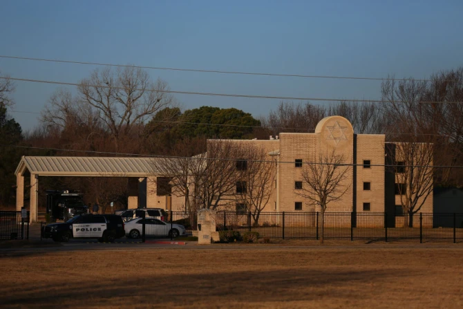 A Police car sits in front of the Congregation Beth Israel Synagogue in Colleyville, Texas, some 25 miles west of Dallas, Jan. 16, 2022.