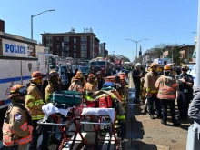 Emergency personnel crowd the streets near a subway station in New York City on April 12, 2022, after at least 16 people were injured during a rush-hour shooting in the Brooklyn borough of New York.
