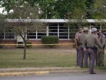 State troopers stand outside of Robb Elementary School in Uvalde, Texas, on May 24, 2022. - An 18-year-old gunman killed 14 children and a teacher at an elementary school in Texas on Tuesday, according to the state's governor, in the nation's deadliest school shooting in years.