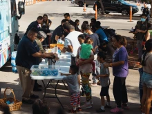 Groups of migrants wait outside the Migrant Resource Center to receive food from San Antonio Catholic Charities on Sept. 19, 2022, in San Antonio, Texas.
