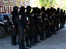 Members of the National Police prepare before going out to patrol the streets of Duran, city neighbouring Guayaquil, Ecuador, on Nov. 5, 2022. Special police forces continued on Friday, Nov. 4, 2022 to transfer imprisoned criminal gang leaders who have unleashed terror in Guayaquil as part of the government's "open war" against drug trafficking.