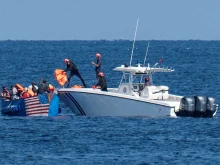 Members of the Cuban Coast Guard hand out life jackets to migrants on a drifting boat in Havana on Dec. 12, 2022.