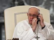 Pope Francis speaks on the phone during the weekly general audience at St. Peter’s Square at the Vatican on May 17, 2023. The Holy Father has called a Holy Family Catholic Parish in Gaza almost every evening since Oct. 9, 2023.