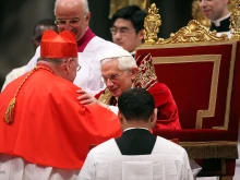 New cardinal Timothy Michael Dolan (L), Archbishop of New York, receives the biretta cap from Pope Benedict XVI in St. Peter's Basilica on Feb. 18, 2012, in Vatican City, Vatican.