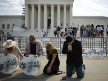 Katie Mahoney, Rev. Pat Mahoney, Peggy Nienaber of Faith and Liberty, and Mark Lee Dickson of Right to Life East Texas pray in front of the U.S. Supreme Court on April 21, 2023, in Washington, D.C.