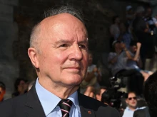 Jean-Louis Georgelin, former chief of staff of the armies and CEO of the public establishment in charge of the conservation and restoration of Notre-Dame de Paris cathedral, waits for the delivery by barge of the timber truss to the cathedral during its restoration in Paris on July 11, 2023.