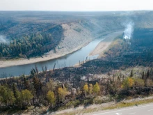 An aerial view shows charred remains on the side of the road beside the highway in Enterprise, Northwest Territories, Canada, on Aug. 20, 2023. Enterprise and Hay River were put on evacuation orders prior to the city of Yellowknife. The town of Enterprise, Northwest Territories, was burned to the ground by forest fires.
