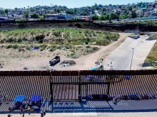 This aerial picture taken on Sept. 14, 2023, shows the U.S.-Mexico border fence with camp shelters left by migrants in San Ysidro, California.