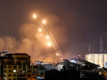 A salvo of rockets is fired by Palestinian militants from Gaza City toward Israel on Oct. 8, 2023. The death toll surged to almost 1,000 since Palestinian militant group Hamas launched its massive surprise attack on Israel with a barrage of rockets and a massive ground assault, officials on both sides said on Oct. 8.