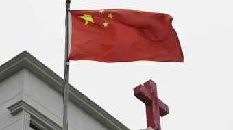 This photo taken on Jan. 15, 2024, shows a Chinese flag fluttering below a cross on a Christian church in Pingtan, in China’s southeast Fujian province.
