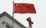 This photo taken on Jan. 15, 2024, shows a Chinese flag fluttering below a cross on a Christian church in Pingtan, in China’s southeast Fujian province.