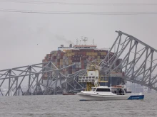 Workers continue to investigate and search for victims after the cargo ship Dali collided with the Francis Scott Key Bridge causing it to collapse yesterday, on March 27, 2024, in Baltimore.