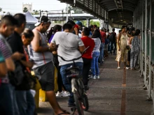 Migrants mostly form Central America wait in line to cross the border at the Gateway International Bridge into the U.S. from Matamoros, Mexico, to Brownsville, Texas, on June 4, 2024.