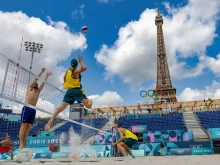 Norwegian players Christian Sorum (left), Anders Mol (second left), and Australian players Zachery Schubert (second right) and Thomas Hodges (right) take part in a practice session ahead of the opening of the Paris 2024 Olympic Games at the Eiffel Tower Stadium in Paris on July 24, 2024.