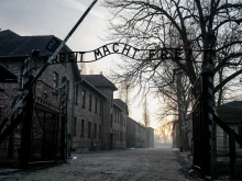 The sun rises over the main gate with the renowned sign “Arbeit Macht Frei” (“Work makes you free”) of the Museum of Auschwitz/Birkenau German Nazi concentration and extermination camp on the 80th anniversary of the liberation of the camp, Monday, Jan. 27, 2025.