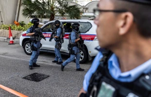 Police with automatic weapons guard outside the West Kowloon court after Hong Kong media mogul Jimmy Lai arrived for his national security trial in Hong Kong on Aug. 15, 2025. Credit: ISAAC LAWRENCE/AFP via Getty Images