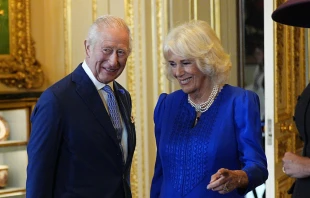 King Charles III and Queen Camilla view items on display during a visit to the Royal Collection exhibition in the Green Drawing Room during the state visit by the president of the United States of America at Windsor Castle on Sept. 17, 2025, in Windsor, England. The royal couple have announced a state visit to the Vatican in late October 2025. Credit: Aaron Chown - WPA Pool/Getty Images