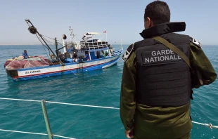 A member of the Tunisia’s national guard stops a fishing boat in the sea bordering Tunisia and Libya as they check vessels for illegal migrants trying to reach Europe, Tuesday, May 5, 2015. Credit: FETHI BELAID/AFP/Getty Images