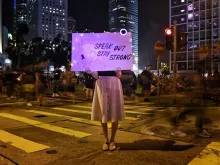 A protester holds a sign at a #MeToo rally in Hong Kong on August 28, 2019, to protest alleged sexual assaults by police. 