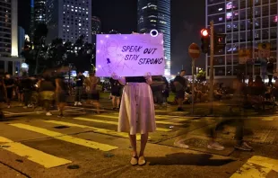 A protester holds a sign at a #MeToo rally in Hong Kong on August 28, 2019, to protest alleged sexual assaults by police.   Lillian SUWANRUMPHA / AFP/ Getty Images