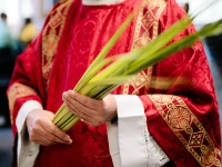 A priest holds palms on Palm Sunday.