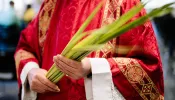 A priest holds palms on Palm Sunday.