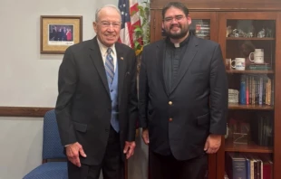 Father Guillermo Treviño Jr.’s national profile stemmed from his immigrant rights work with Escucha Mi Voz Iowa (“Hear My Voice Iowa”), a group aiding Latino workers, including immigrants. He is shown here during a meeting earlier this year with U.S. Sen.Chuck Grassley, R-Iowa. Credit: Photo courtesy of Escucha Mi Voz Iowa
