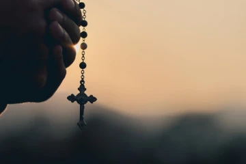 Hands praying rosary
