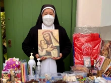 A member of the Dominican Sisters’ Congregation of St. Rose of Lima in northern Italy sells prints at the Santa’s Sanctuary of Lima.