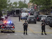 First responders take away victims from the scene of a mass shooting at a Fourth of July parade on July 4, 2022 in Highland Park, Illinois. At least six people were killed and 19 injured, according to published reports.