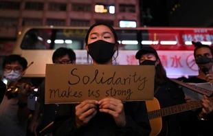 People attend a flash mob singing event outside Chungking Mansions in Tsim Sha Tsui district in Hong Kong on October 23, 2019.    PHILIP FONG/AFP via Getty Images