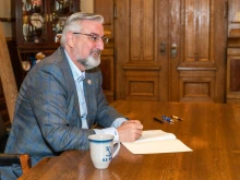 Indiana Governor Eric Holcomb signs bills in Indianapolis, March 10, 2022.