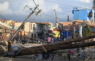 Electrical poles are down as a man bikes through the destroyed neighborhood of North Street following the passage of Hurricane Melissa in Black River, Jamaica, on Oct. 29, 2025. Credit: Ricardo Makyn/Getty