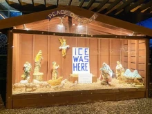 A Nativity display with anti-ICE messaging outside St. Susanna Church in Dedham, Massachusetts.
