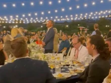 Attendees at a gathering sponsored by the Napa Institute sing the "Salve Regina" to drone out protesters who demonstrated at the Meritage Resort and Spa in Napa, California, on July 30, 2022.