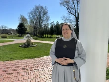 Mother Marla Marie stands on the front porch of the sisters’ Mother of the Light convent in Dartmouth, Massachusetts.