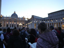 Pilgrims pray in front of St. Peter's Basilica