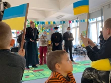 Archbishop Zbigņev Stankevičs of Riga visits Ukrainian refugees at the Registration Center for Ukrainians in Riga, Latvia, March 25, 2022.