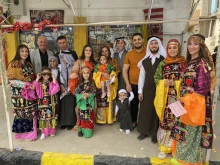 A Christian family in Qaraqosh sporting their traditional dressing for Holy Week in April 2022.