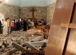 Iraqis survey damage to a church attacked by terrorists?w=200&h=150