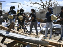 Residents help move food supplies at a community center before distribution to the Whitehouse community in Westmoreland, Jamaica, one of the areas most severely affected by the passage of Hurricane Melissa, on Nov. 2, 2025.