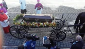 The coffin of Cardinal Josef Beran is carried by a horse-drawn carriage toward St. Vitus Cathedral in Prague on April 21, 2018. The cardinal’s remains were repatriated to his homeland 49 years after his death in exile in Rome.