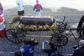 The coffin of Cardinal Josef Beran is carried by a horse-drawn carriage toward St. Vitus Cathedral in Prague on April 21, 2018. The cardinal’s remains were repatriated to his homeland 49 years after his death in exile in Rome.