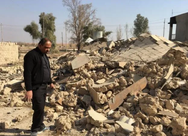A priest examines a church destroyed by Islamic State militants in Karemlesh. Photo courtesy of the Knights of Columbus.?w=200&h=150